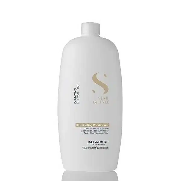White plastic bottle of Illuminating Conditioner with a gold emblem and minimalist label on the front (hair care product).